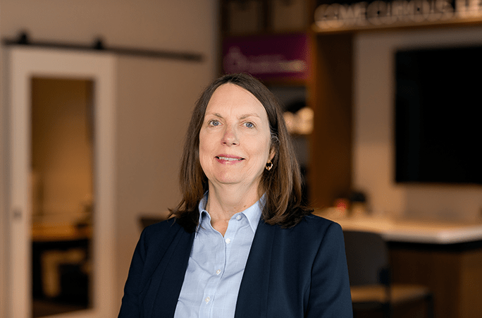 A portrait of Carolyn Welch inside a bank