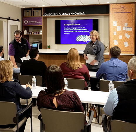 A man and women lecturing a classroom of 7 students