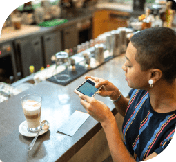 A woman uses a smartphone to scan a check for online banking